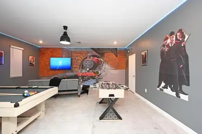 a living room with a pool table and a tv at 2956 - Sanctuary at Storey Lake in Kissimmee