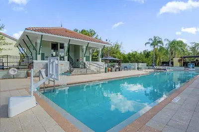 a swimming pool in front of a house at 14531 Damai in Orlando