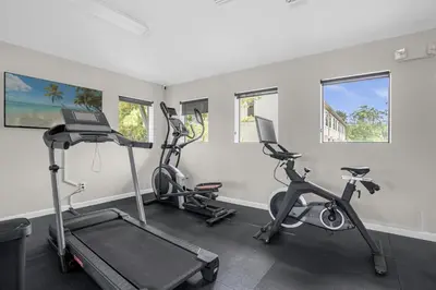 a gym with three exercise bikes in a room at 14531 Damai in Orlando