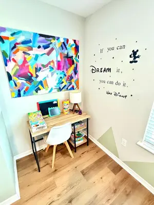 a room with a desk and a painting on the wall at Boho retreat close to Disney! in Kissimmee