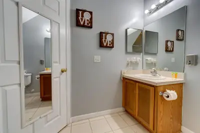 a bathroom with a sink and a mirror at Comfy Townhome Minutes from Disney in Orlando
