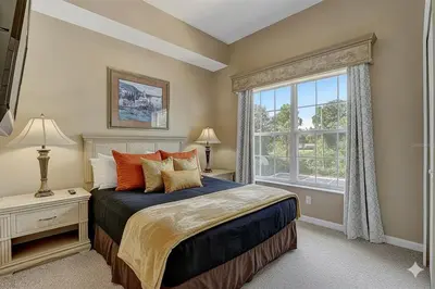a bedroom with a bed and a large window at Stay at Disney in Orlando