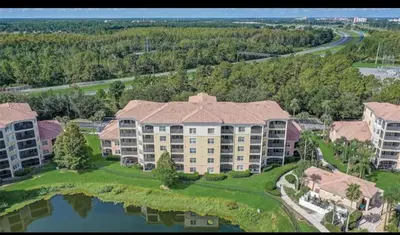 an aerial view of a large apartment building with a lake at Stay at Disney in Orlando