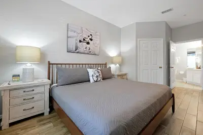 a bedroom with a bed and a table with a lamp at Spring Break Awaits Disney Close Pool Slides Fun in Orlando