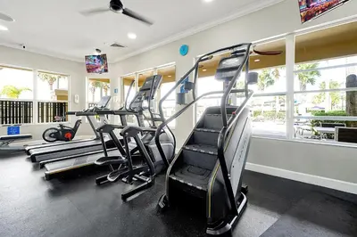 a gym with treadmills and ellipticals in a room at Spring Break Awaits Disney Close Pool Slides Fun in Orlando