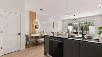 a kitchen and dining room with a counter and a table at Upstay-Luxury 3BR Home w Private Pool & Games Room in Orlando