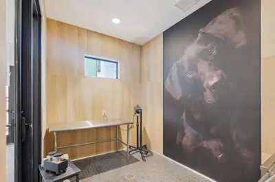 a bathroom with a large painting of a dog on the wall at Kissimmee Oasis in Orlando