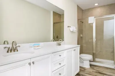a white bathroom with a sink and a toilet at Cheerful Villa Near Disney With Margaritaville Resort And Island H20 Waterpark Access - 2913Cs in Orlando