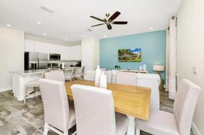 a dining room and kitchen with a table and chairs at Cheerful Villa Near Disney With Margaritaville Resort And Island H20 Waterpark Access - 2913Cs in Orlando