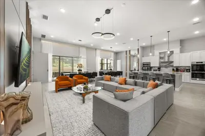 a living room with a gray couch and orange chairs at 15 Bedrooms 165 Bathrooms Sonoma 4171Sb in Kissimmee