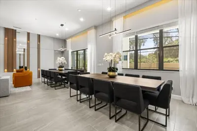 a dining room with a table and black chairs at 15 Bedrooms 165 Bathrooms Sonoma 4171Sb in Kissimmee