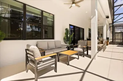a patio with chairs and a couch and a table at 15 Bedrooms 165 Bathrooms Sonoma 4171Sb in Kissimmee
