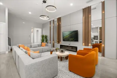 a living room with a couch and orange chairs at 15 Bedrooms 165 Bathrooms Sonoma 4171Sb in Kissimmee