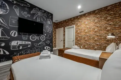 a bedroom with two beds and a brick wall at Elegant Orlando Getaway Close To Disney in Kissimmee