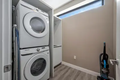 a laundry room with a washer and dryer at Elegant Orlando Getaway Close To Disney in Kissimmee