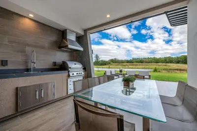 a kitchen and dining room with a large window at Elegant Orlando Getaway Close To Disney in Kissimmee