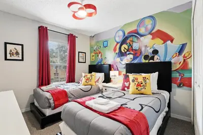 a bedroom with two beds and a painting on the wall at Family Escape Near Disney Serene Retreat in Terra Verde Resort in Kissimmee