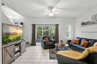 a living room with a couch and a tv at Family Escape Near Disney Serene Retreat in Terra Verde Resort in Kissimmee