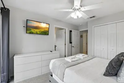 a white bedroom with a bed and a ceiling fan at Family Escape Near Disney Serene Retreat in Terra Verde Resort in Kissimmee
