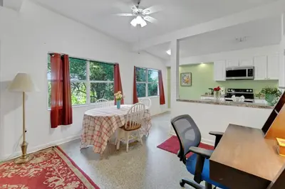 a kitchen and dining room with a table and chairs at Orlando 3BR | Hot Tub + Parking + Pets in Orlando