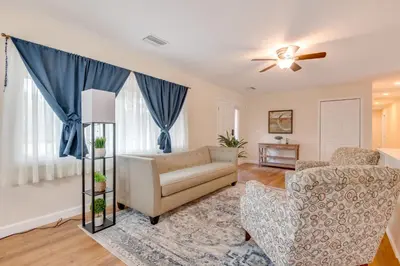 a living room with a couch and a chair at 15 Mi to Dtwn Orlando Spacious Family Home in Orlando