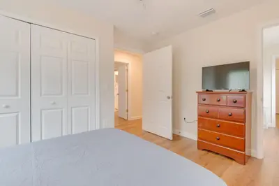a bedroom with a bed and a tv and a dresser at 15 Mi to Dtwn Orlando Spacious Family Home in Orlando