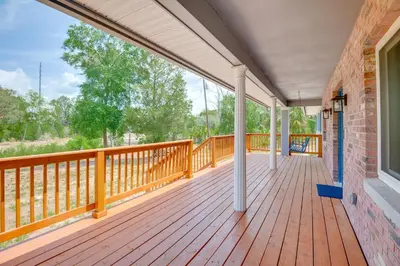 a large porch with a wooden deck at 15 Mi to Dtwn Orlando Spacious Family Home in Orlando