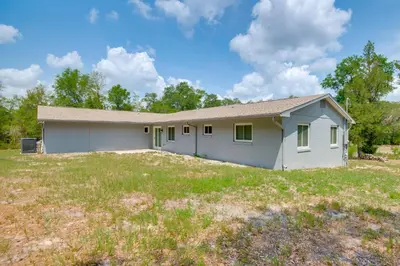 a house on a grassy field with a house at 15 Mi to Dtwn Orlando Spacious Family Home in Orlando