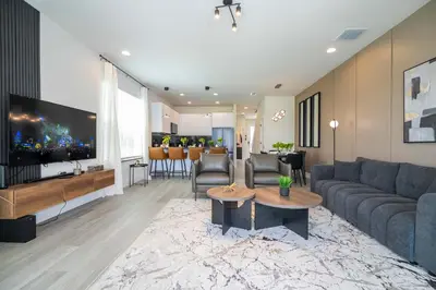 a living room with a couch and a tv at Family Friendly w Pool near Disney at Serenity 1420 in Orlando