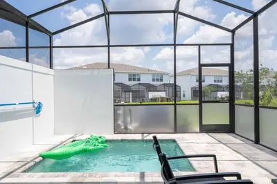 a swimming pool in a house with a large window at Family Friendly w Pool near Disney at Serenity 1420 in Orlando