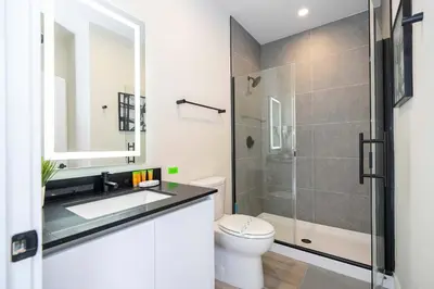 a bathroom with a shower and a sink and a toilet at Family Friendly w Pool near Disney at Serenity 1420 in Orlando