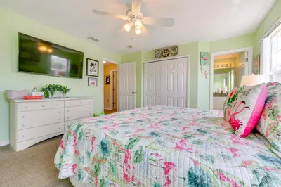 a bedroom with a bed and a ceiling fan at 10 Mi to Disney Parks Resort Retreat with Patio in Kissimmee