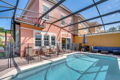 a swimming pool in front of a house at 10 Mi to Disney Parks Resort Retreat with Patio in Kissimmee