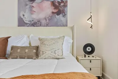 a bedroom with a bed with a painting on the wall at Grand 15-Bedroom Villa -Magical Themes, Pool & Game Loft, Lakeview in Kissimmee