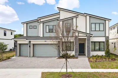 a large house with a garage at Grand 15-Bedroom Villa -Magical Themes, Pool & Game Loft, Lakeview in Kissimmee