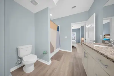 a white bathroom with a toilet and a sink at 3204 GL - Serene Lucaya Oasis Retreat in Kissimmee