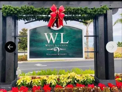 a sign for the west lincoln village resort with a red bow at 3204 GL - Serene Lucaya Oasis Retreat in Kissimmee