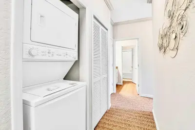 a white laundry room with a washer and dryer at Pet-Friendly Condo w Pool Near Disney in Orlando