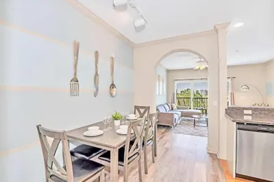 a kitchen and dining room with a table and chairs at Pet-Friendly Condo w Pool Near Disney in Orlando