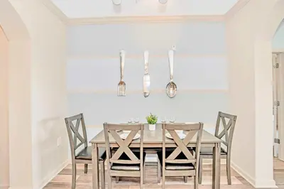 a dining room with a wooden table and chairs at Pet-Friendly Condo w Pool Near Disney in Orlando
