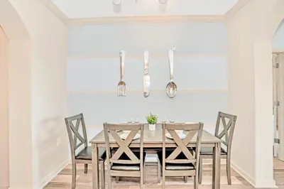 a dining room with a wooden table and chairs at Upstay Modern 3BR Getaway w Pool in Orlando