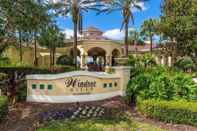 a mansion with a sign in front of a yard at Water Park & Fantastic Pool only Minutes To Walt Disney World's Front Gate!!! in Orlando