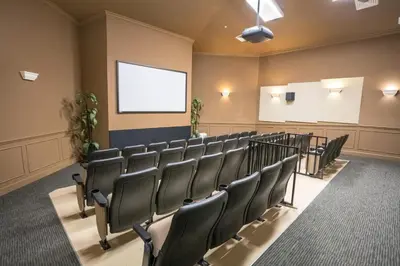 a lecture room with a bunch of chairs and a screen at Water Park & Fantastic Pool only Minutes To Walt Disney World's Front Gate!!! in Orlando
