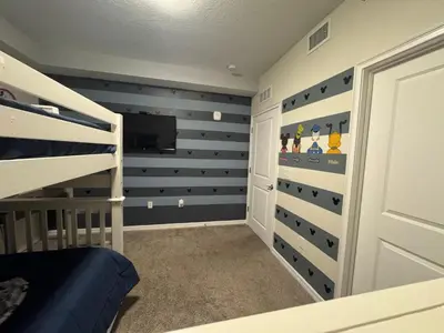 a bedroom with a bunk bed and a tv at 2 Bedrooms Apartment in Storey Lake in Kissimmee