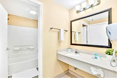 a bathroom with a sink and a mirror at Comfortable Suite Near Disney w Pool and Hot Tub in Orlando