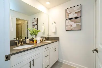 a bathroom with two sinks and a mirror at Stylish Home & Free Resort Access 2420 in Kissimmee