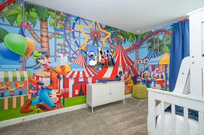 a childs room with a disney mural on the wall at Stylish Home & Free Resort Access 2420 in Kissimmee