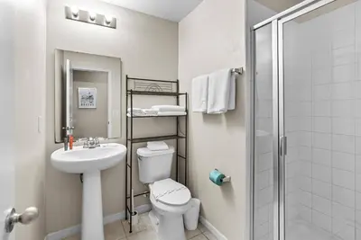 a bathroom with a toilet and a sink and a shower at Amazing 4 Bedrooms- Near Disney in Kissimmee