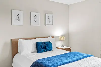 a bedroom with a bed with a blue blanket at Amazing 4 Bedrooms- Near Disney in Kissimmee