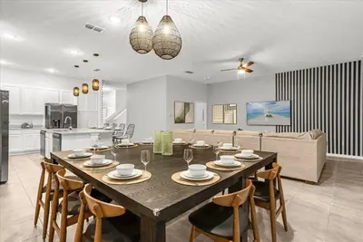 a dining room and kitchen with a table and chairs at Upstay Bella Vida Resort - Resort-Style 12BR Villa in Kissimmee